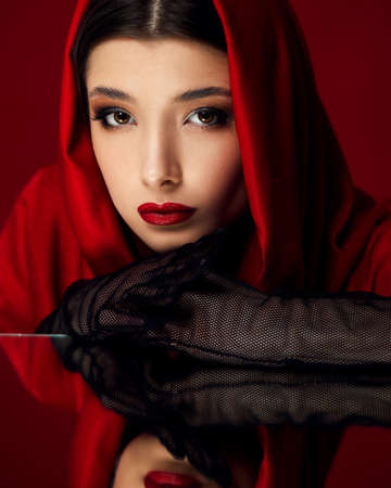 brunette woman with long hair and bright make-upの写真素材