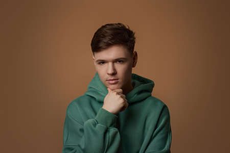 young handsome guy touch his chin by hand thinkingの写真素材