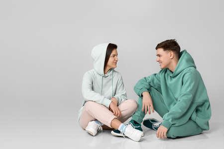 young couple wearing mint green casual hoodieの写真素材
