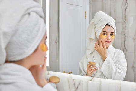 beautiful woman with eye patches in white bathrobes in bathroom