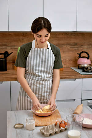 Young beautiful housewife cooking on kitchen at home.の写真素材
