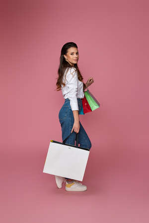 beautiful woman holding shopping bags with purchasesの写真素材