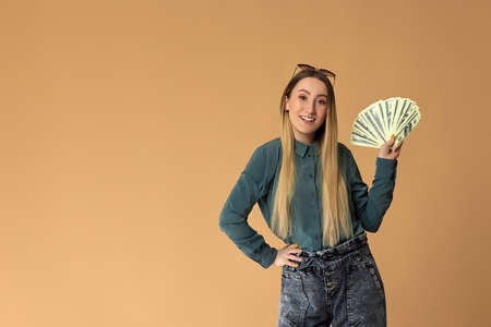 woman holds cash money in dollar banknotes
