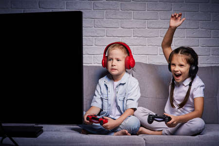 children playing video game with game consoleの写真素材