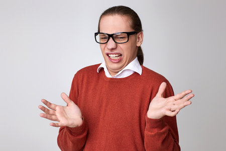 portrait of disgusted man in glasses and shirtの写真素材