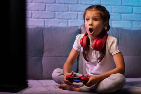 children playing video game with game consoleの写真素材