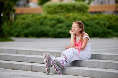 cute little girl on roller skates at park.