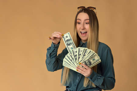 woman holds cash money in dollar banknotesの写真素材