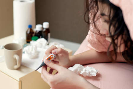 sick girl having influenza symptoms coughing at homeの写真素材