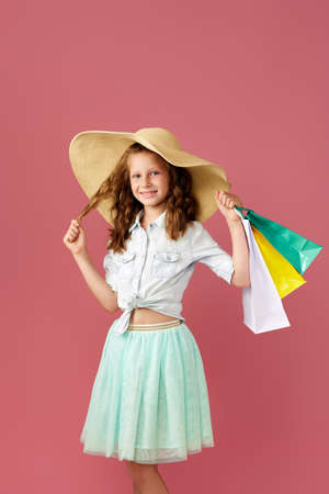 cute little caucasian child girl holds shopping bagsの写真素材