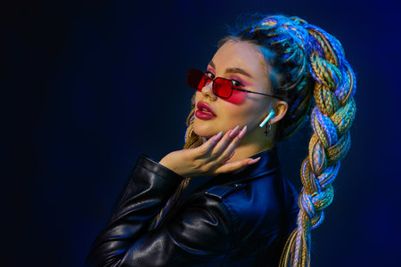young woman with dreadlocks in red sunglasses