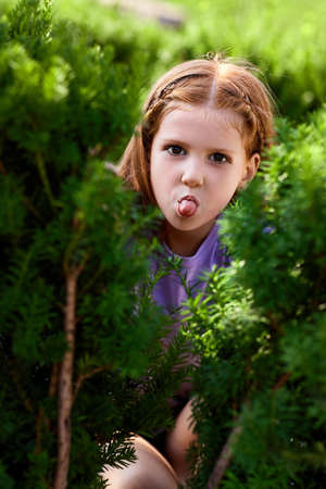 portrait of happy child girl in the parkの写真素材