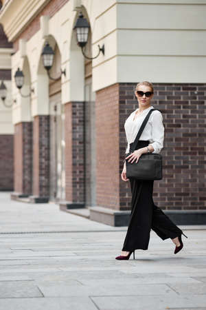 beautiful woman in sunglasses in the streetの写真素材