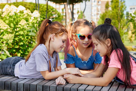 happy cute children girls playing together in the park.の写真素材