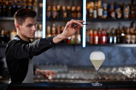 barman is making cocktail with smoky air bubbleの写真素材