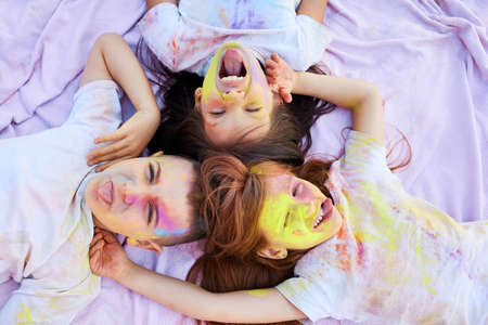 children with colored powder having fun outdoor.の写真素材