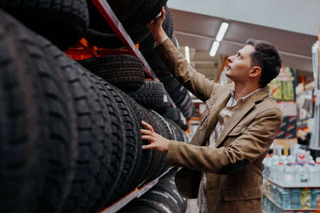 male customer choosing new tires in the supermarket .の写真素材