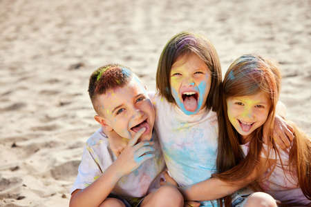 kids having fun by playing with colored powder