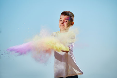 happy little child girl throw bright paintsの写真素材
