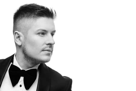 Confident attractive young man in black tuxedoの写真素材