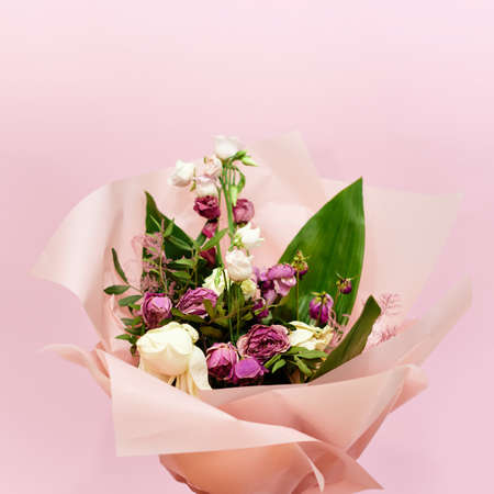 bouquet of dying flowers on pink backgroundの写真素材