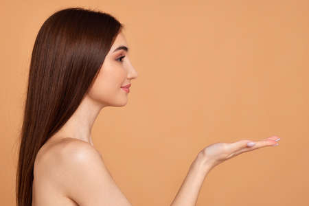 attractive young woman holding on palm copy spaceの写真素材