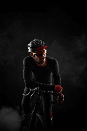 male cyclist with road bicycle on black backgroundの写真素材