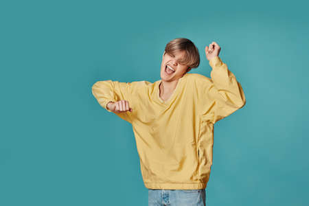 young man in casual yellow clothes dancing