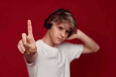 man with headphones pressing button on virtual screensの写真素材