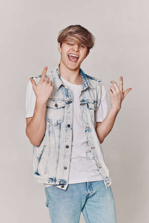 handsome man in denim showing victory gesture