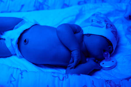 New born baby under the ultraviolet lamp.の写真素材