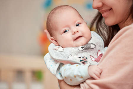 Young mother holding adorable newborn baby
