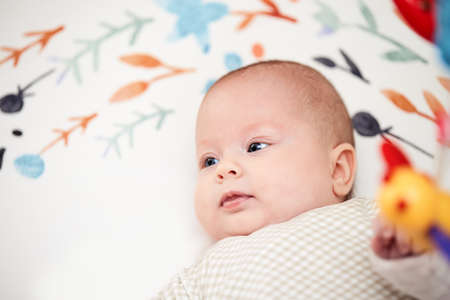 happy newborn baby in crib at home