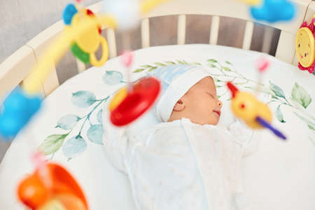 adorable new born baby sleeping in bed