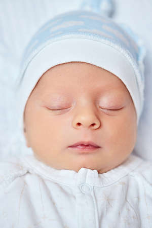 adorable new born baby sleeping in bed