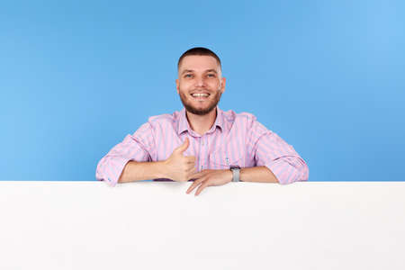 cheerful man holding board with empty copy spaceの写真素材