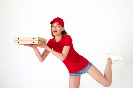 pizza delivery woman in uniform holding pizza boxesの写真素材