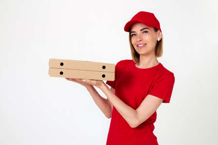 pizza delivery woman in uniform holding pizza boxesの写真素材