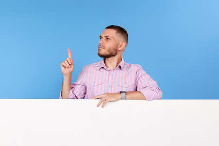 cheerful man holding board with empty copy spaceの写真素材