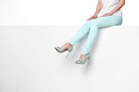 female legs in turquoise trousers and high heels shoesの写真素材