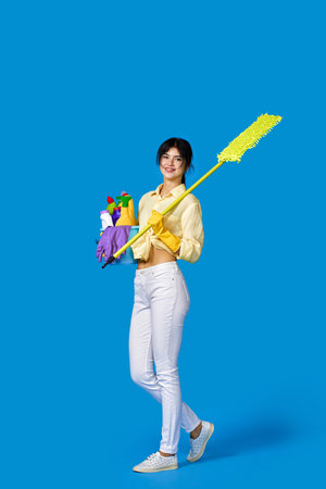 woman in rubber gloves with cleaning suppliesの写真素材