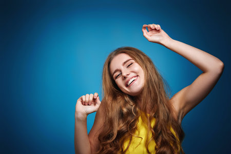 pretty woman with strong healthy curly hair looking on pink background.の写真素材