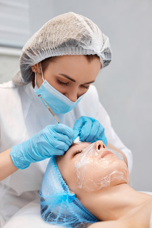 woman during a mechanical face cleansing procedureの写真素材