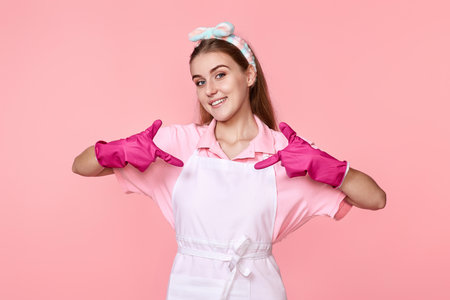 woman in rubber gloves pointing oneself with fingersの写真素材