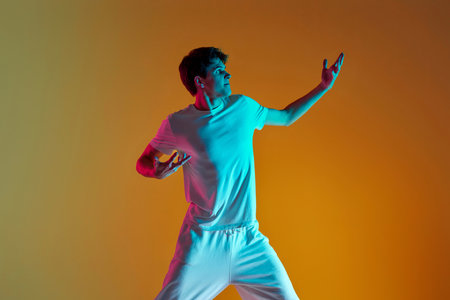 man dancing on yellow background. Neon lightingの写真素材
