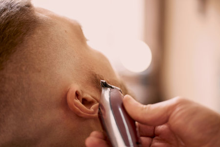 Barber shaving caucasian man in barber shopの写真素材
