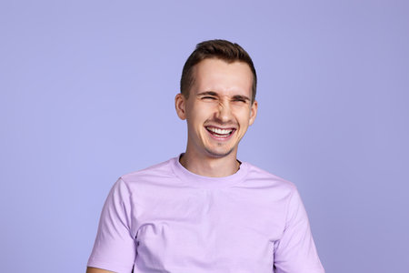 positive handsome man smiling on studio backgroundの写真素材