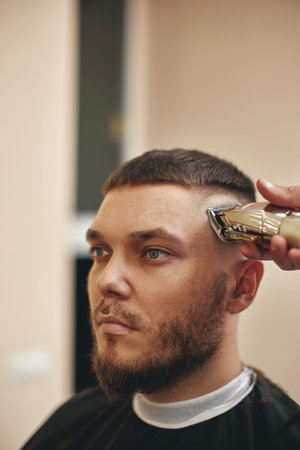 Barber shaving caucasian man in barber shop