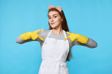 woman in rubber gloves pointing oneself with fingersの写真素材