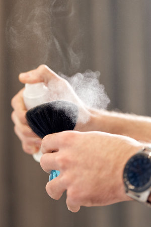 barber holding brush for talco in barber shopの写真素材